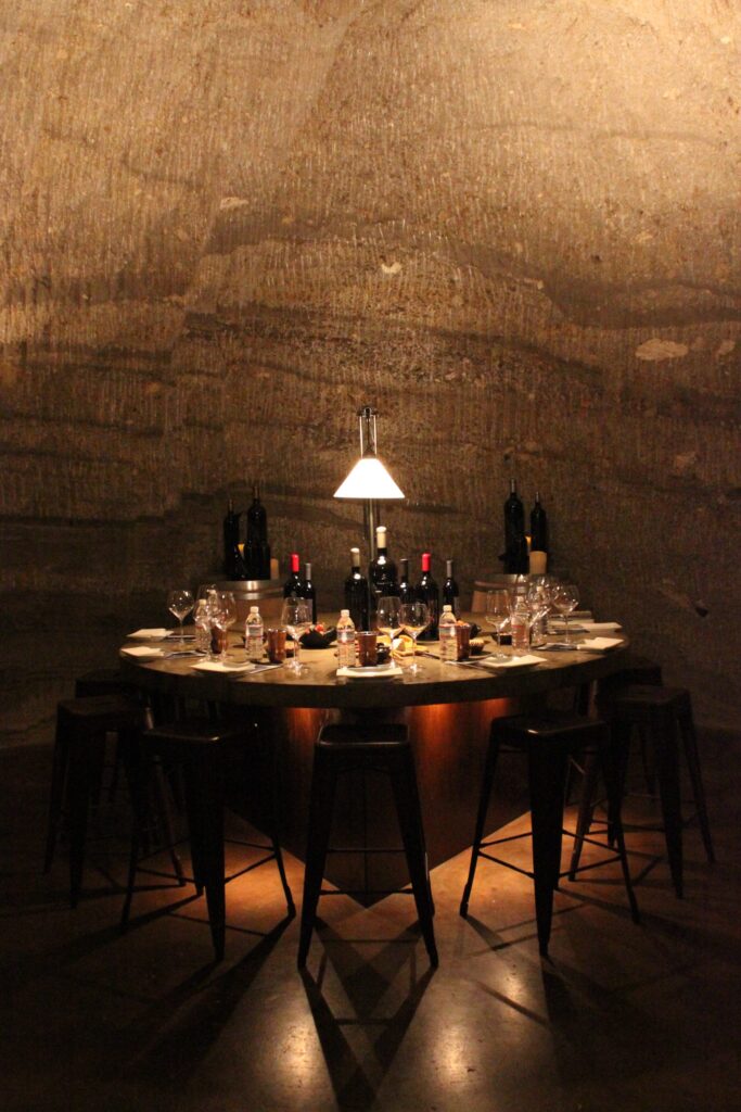 Photograph of a beautifully laid out table for a tasting and dinner in a wine cave.
